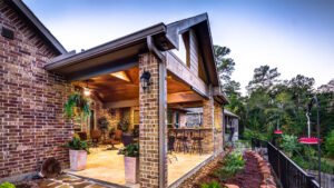 Attached Custom Covered Patio with Summer Kitchen by Creekstone Outdoor Living